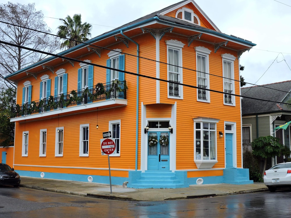 an orange and blue building with a blue door