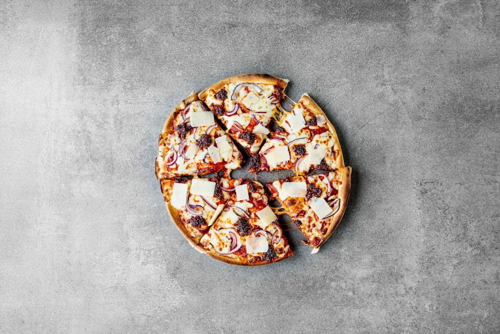 a sliced pizza sitting on top of a table