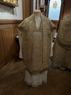 Close-up of richly embroidered vestments worn by the celebrant in a vibrant, traditional setting.