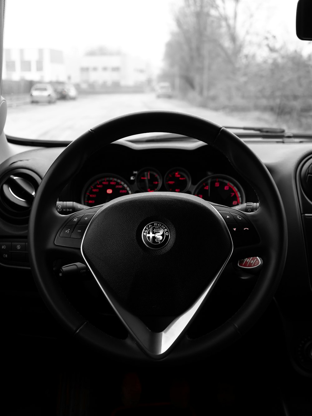 a car dashboard with a steering wheel and dashboard lights