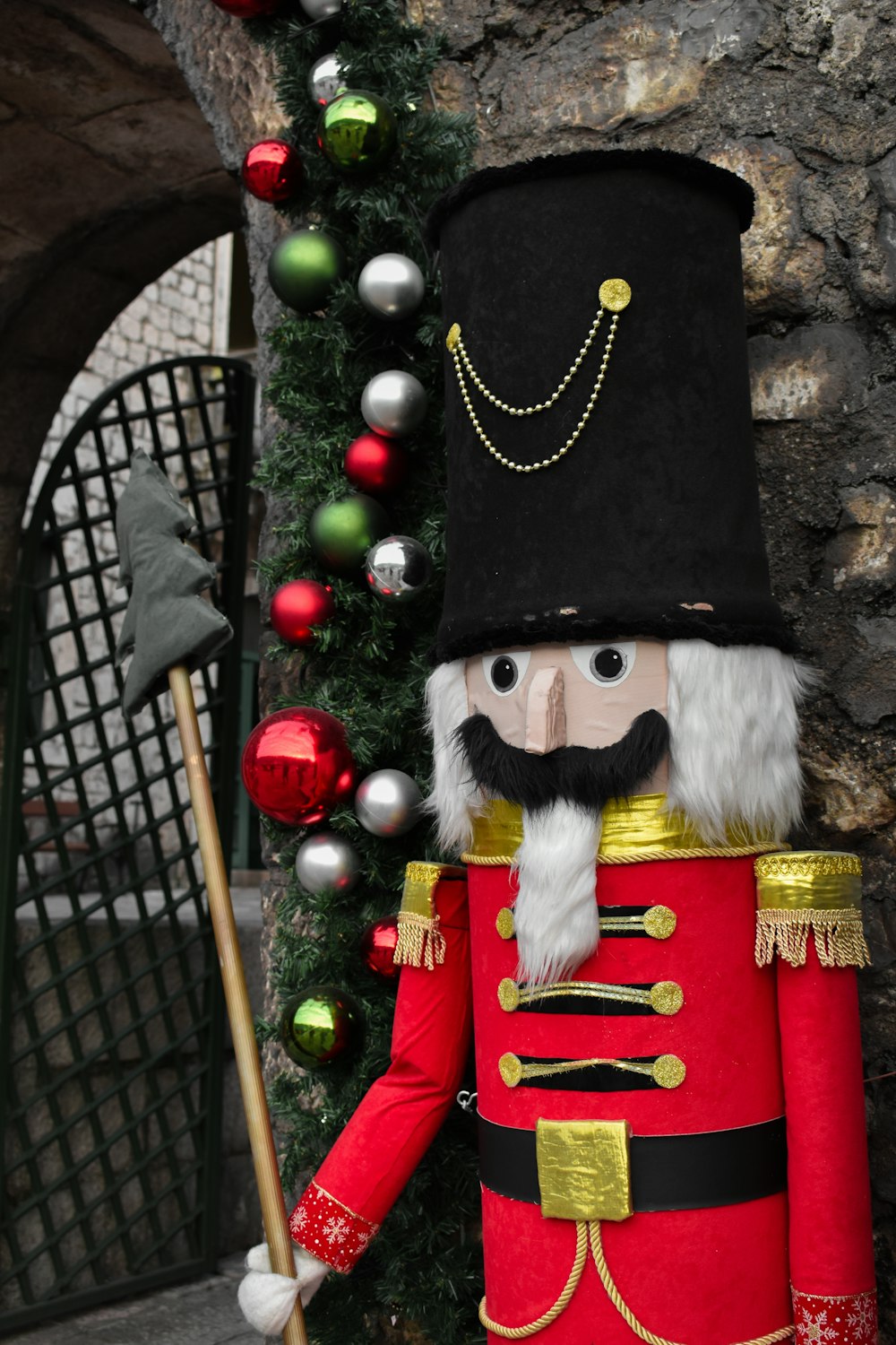 a nutcracker is standing in front of a christmas tree