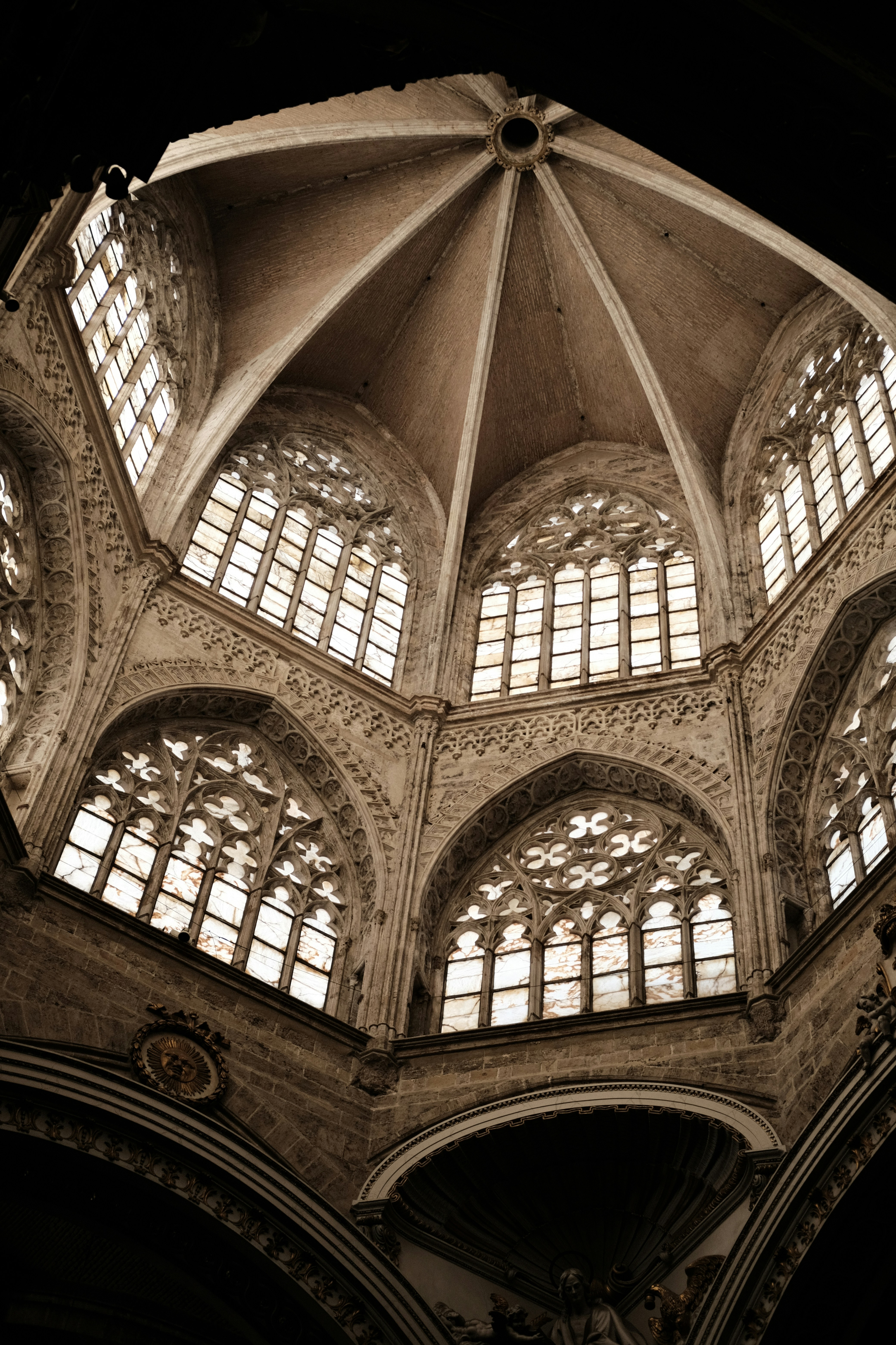 the ceiling of a large building with many windows