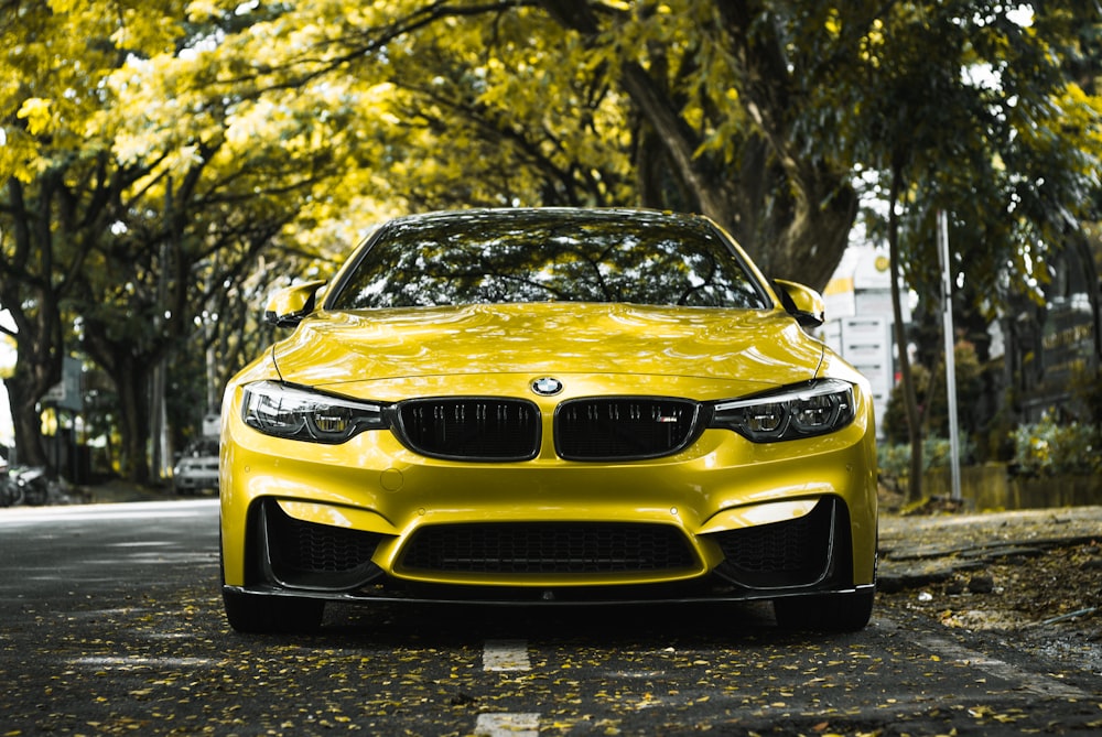 a yellow car parked on the side of the road