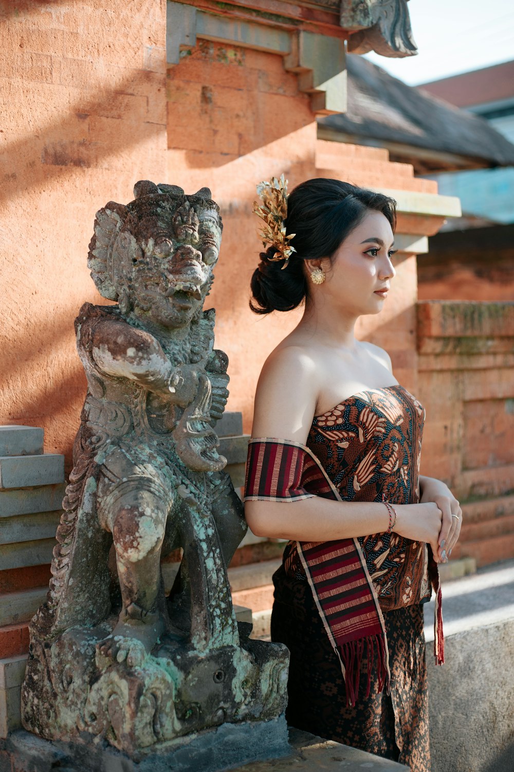 a woman standing next to a statue of a dog