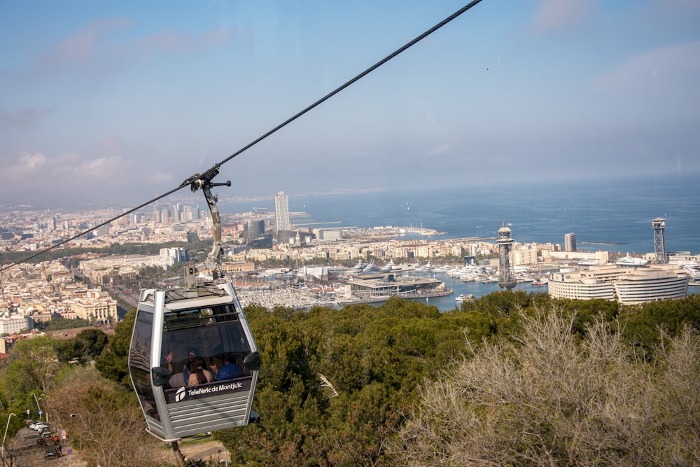 a cable car going up a hill with a city in the background