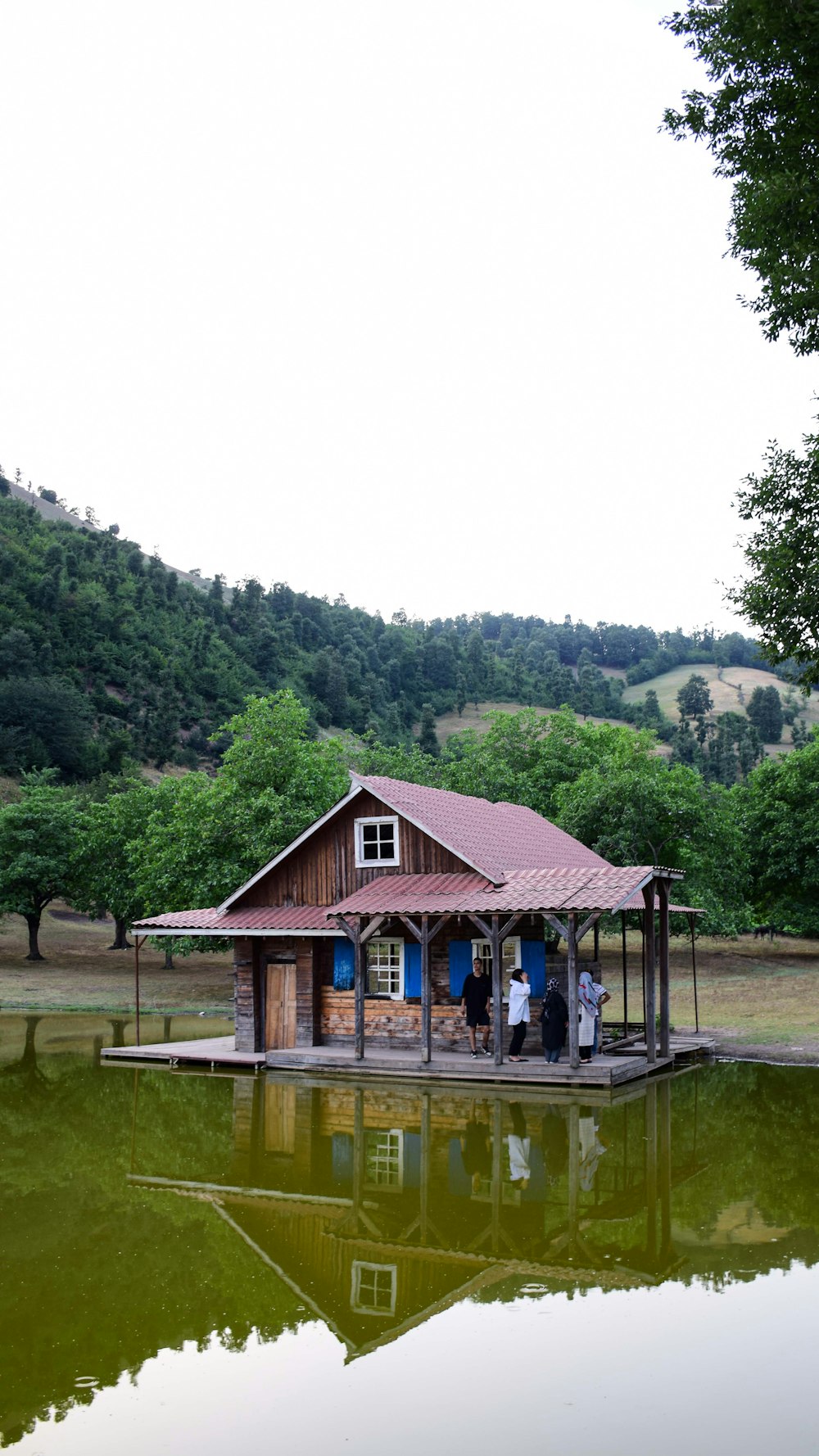 a small cabin sitting on top of a lake