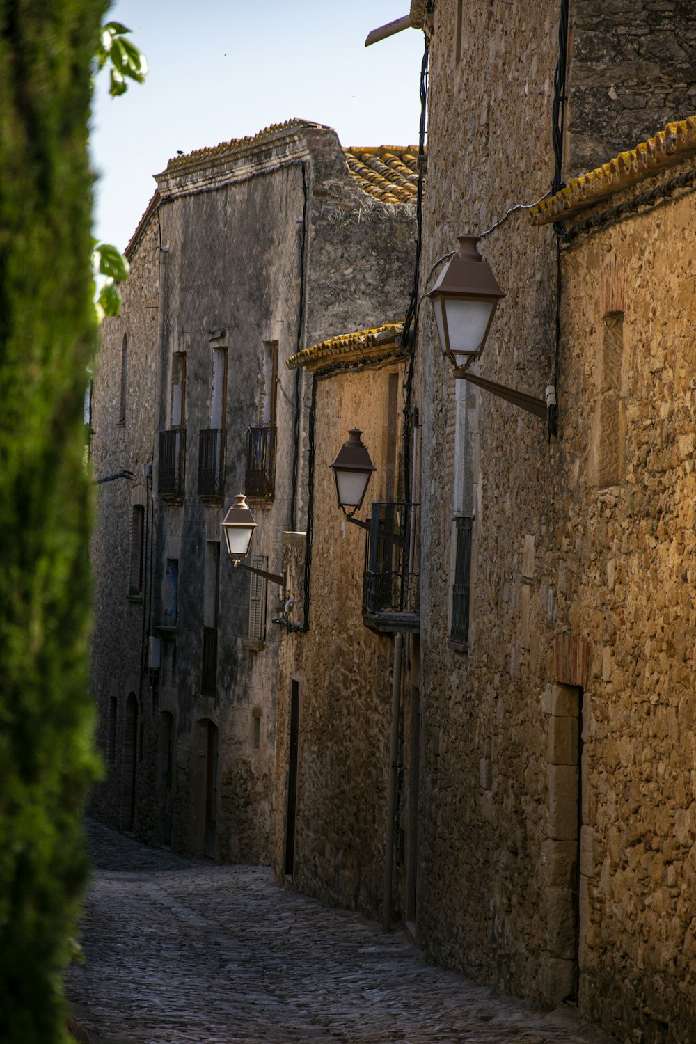 a cobblestone street lined with stone buildings