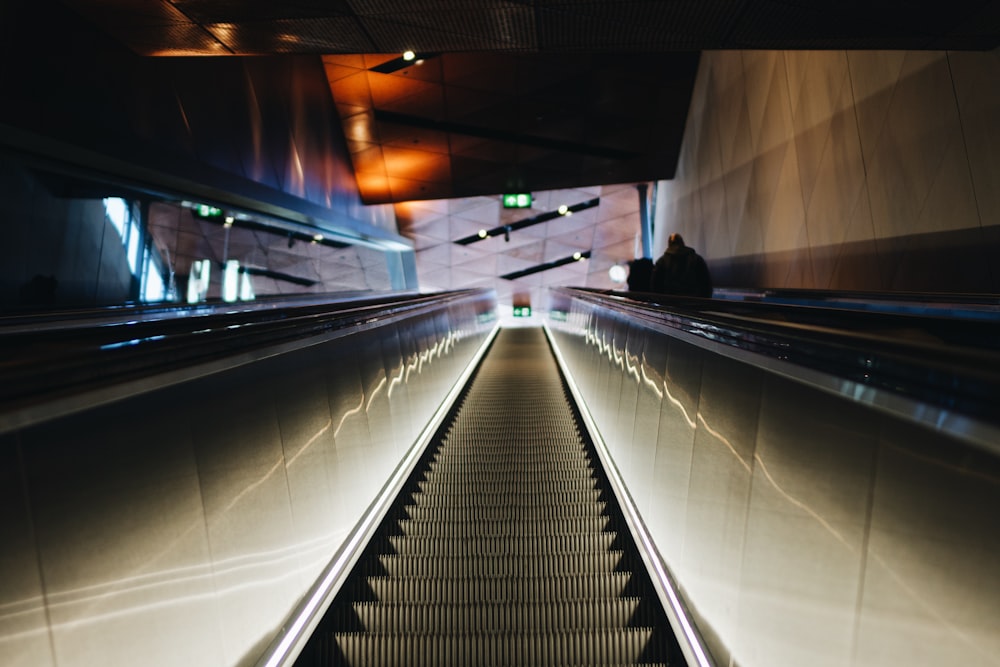 an escalator in a building with a person sitting on it