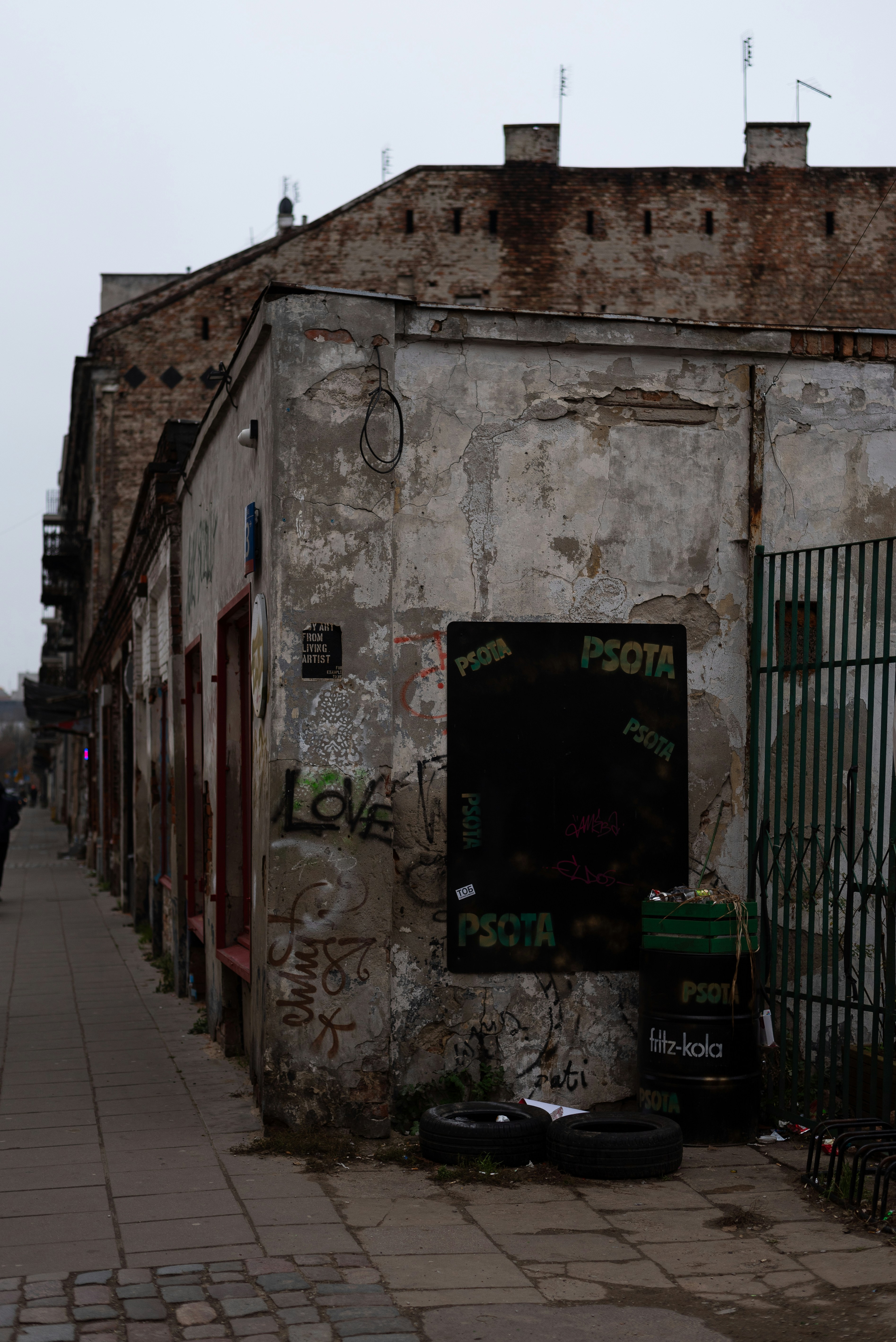 an old building with graffiti on the side of it