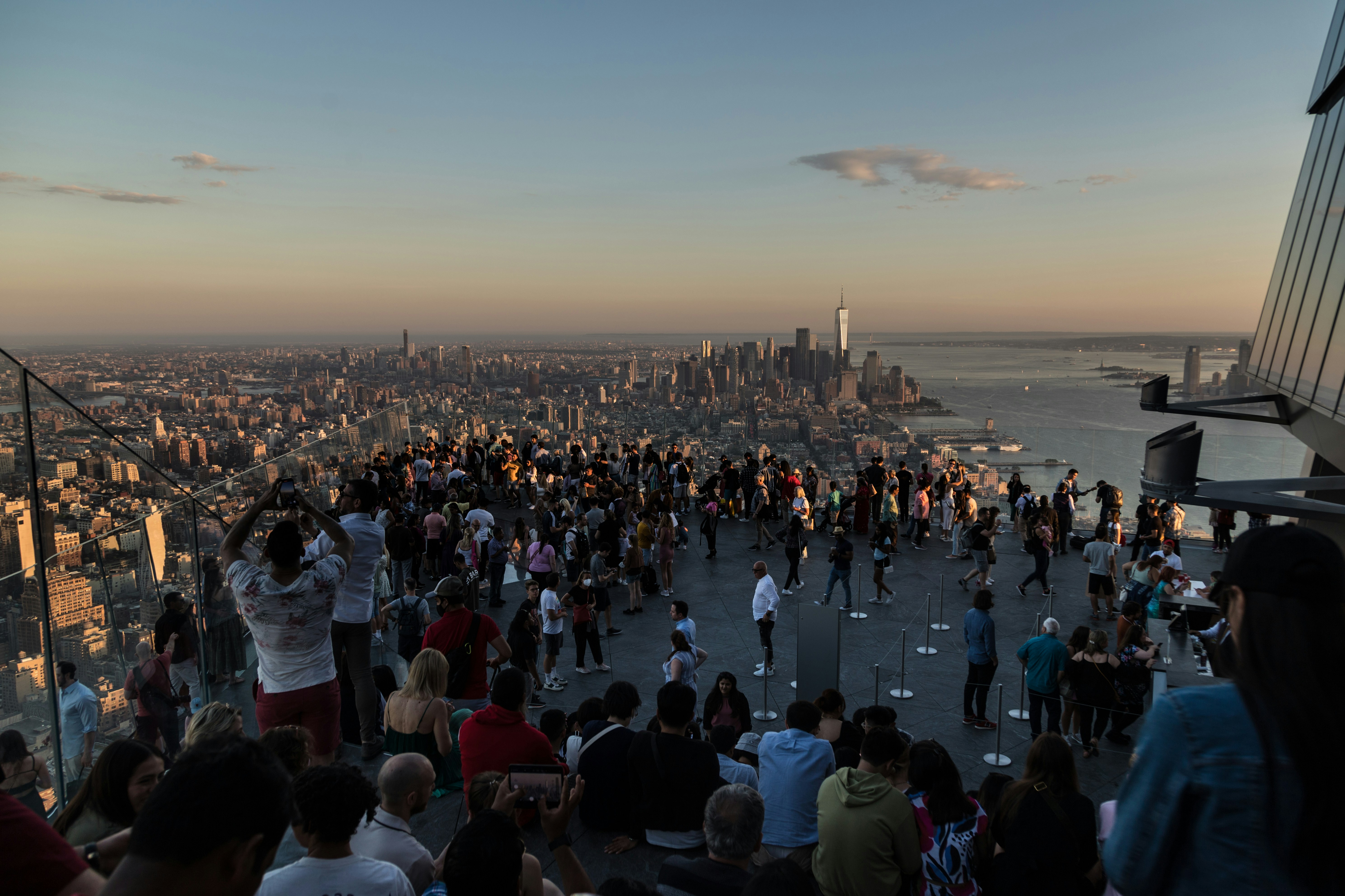 A crowd of people standing on top of a tall building photo – Free New ...