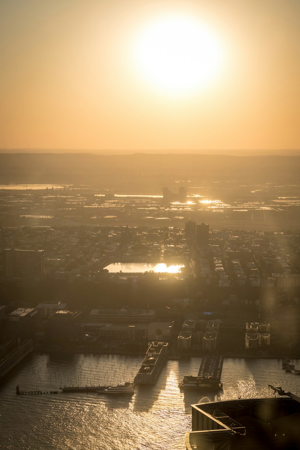 the sun is setting over a large body of water