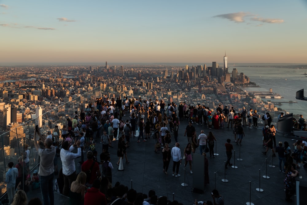 a crowd of people standing on top of a tall building