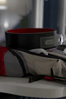 A sleek, modern fitness bag placed on a gym locker with workout gear inside