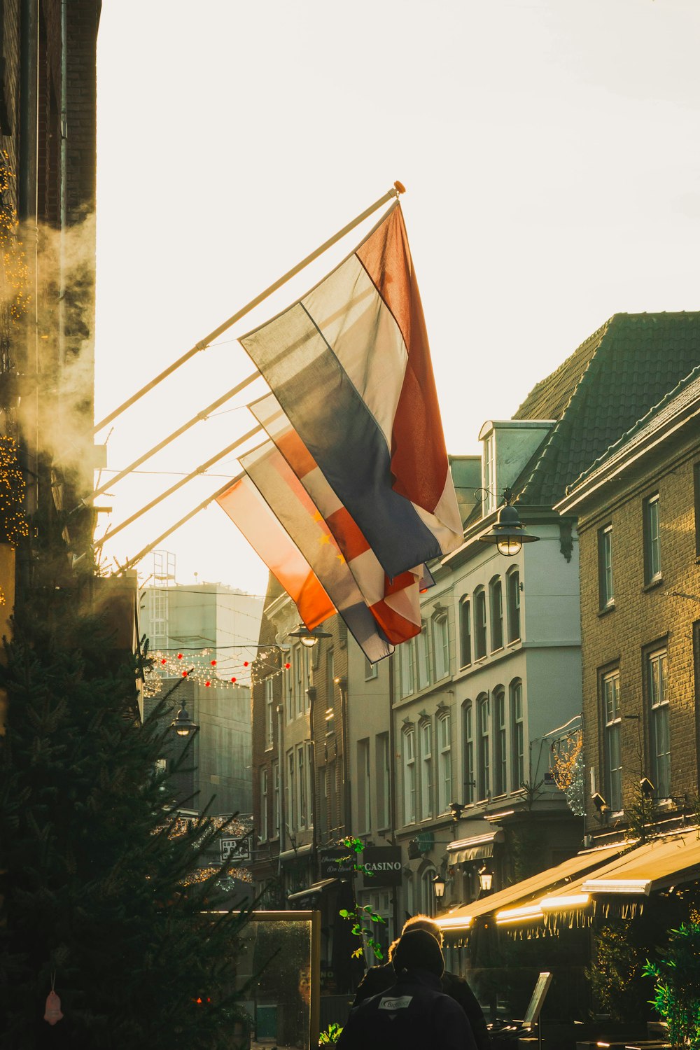 a person walking down a street with a flag in the air