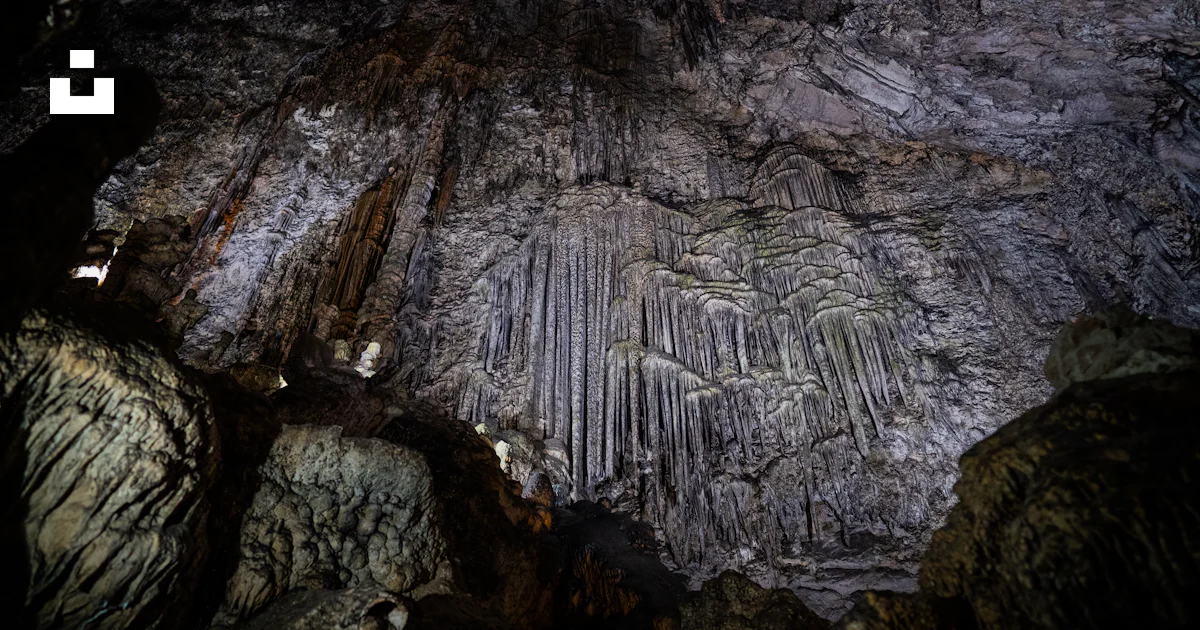 A cave filled with lots of tall rocks photo – Free Spain Image on Unsplash