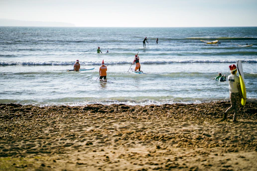 Guests enjoying vibrant water sports under a sunny sky on North Goa’s beach.