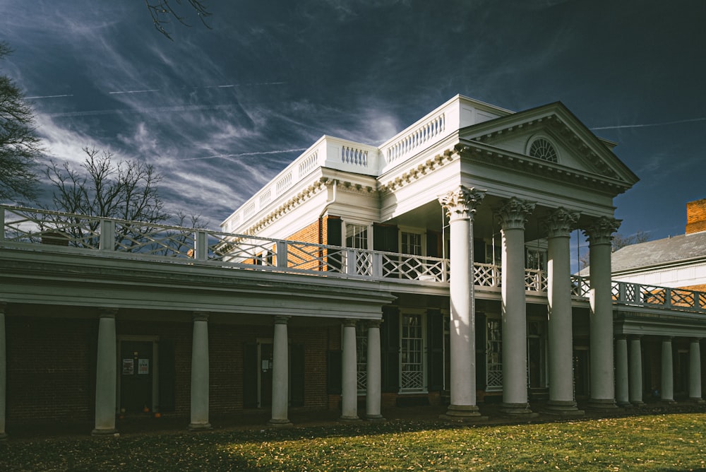 a large white building with columns and a balcony