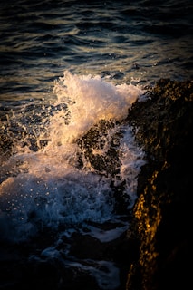 The rugged coastline of Namibia with waves crashing against rocky shores at sunset.