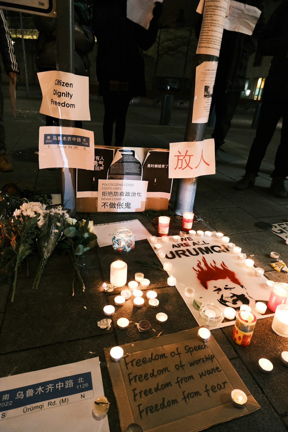 a group of people standing around a bunch of candles