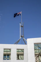 An Australian flag subtly waving in the background of a modern mechanic’s workspace.