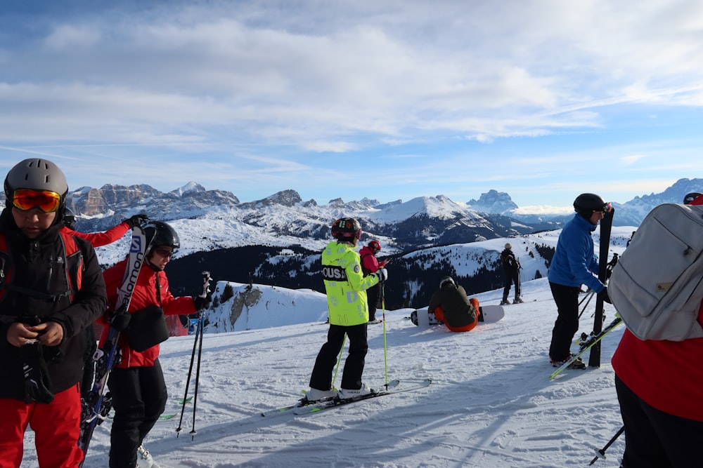 a group of people standing on top of a snow covered slope