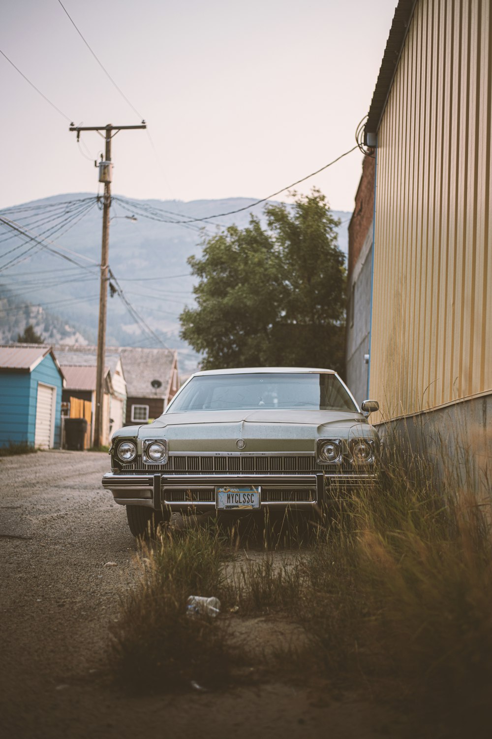 an old car parked in front of a building