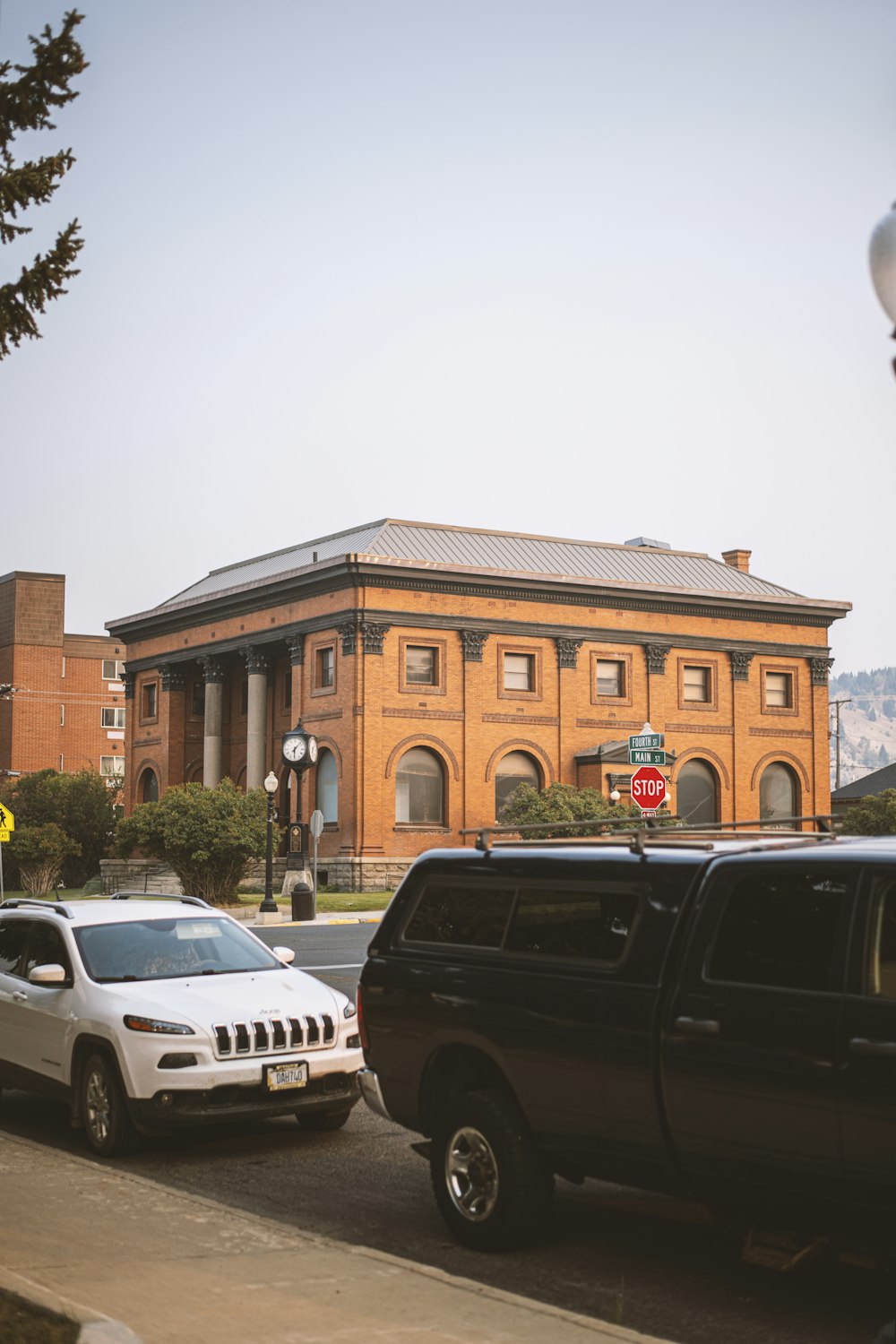 two cars parked in front of a large building