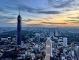 An aerial view of a bustling city skyline at sunset.