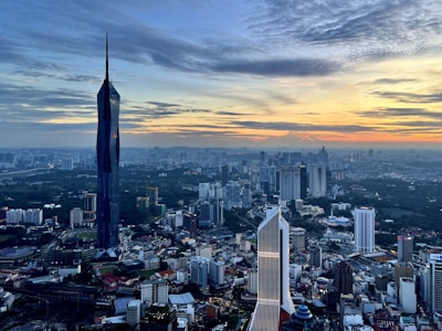 Aerial shot of a vibrant cityscape at sunset showcasing urban architecture.