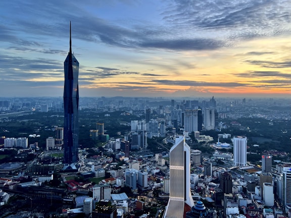 An aerial view of a bustling city skyline at sunset.
