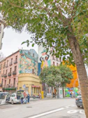 Artistic shot of a city street in São Paulo decorated with vibrant murals and subtle cannabis motifs.