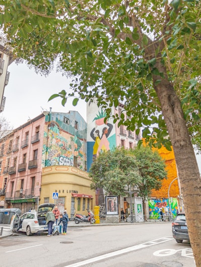 A vibrant street scene in an urban setting with colorful murals.