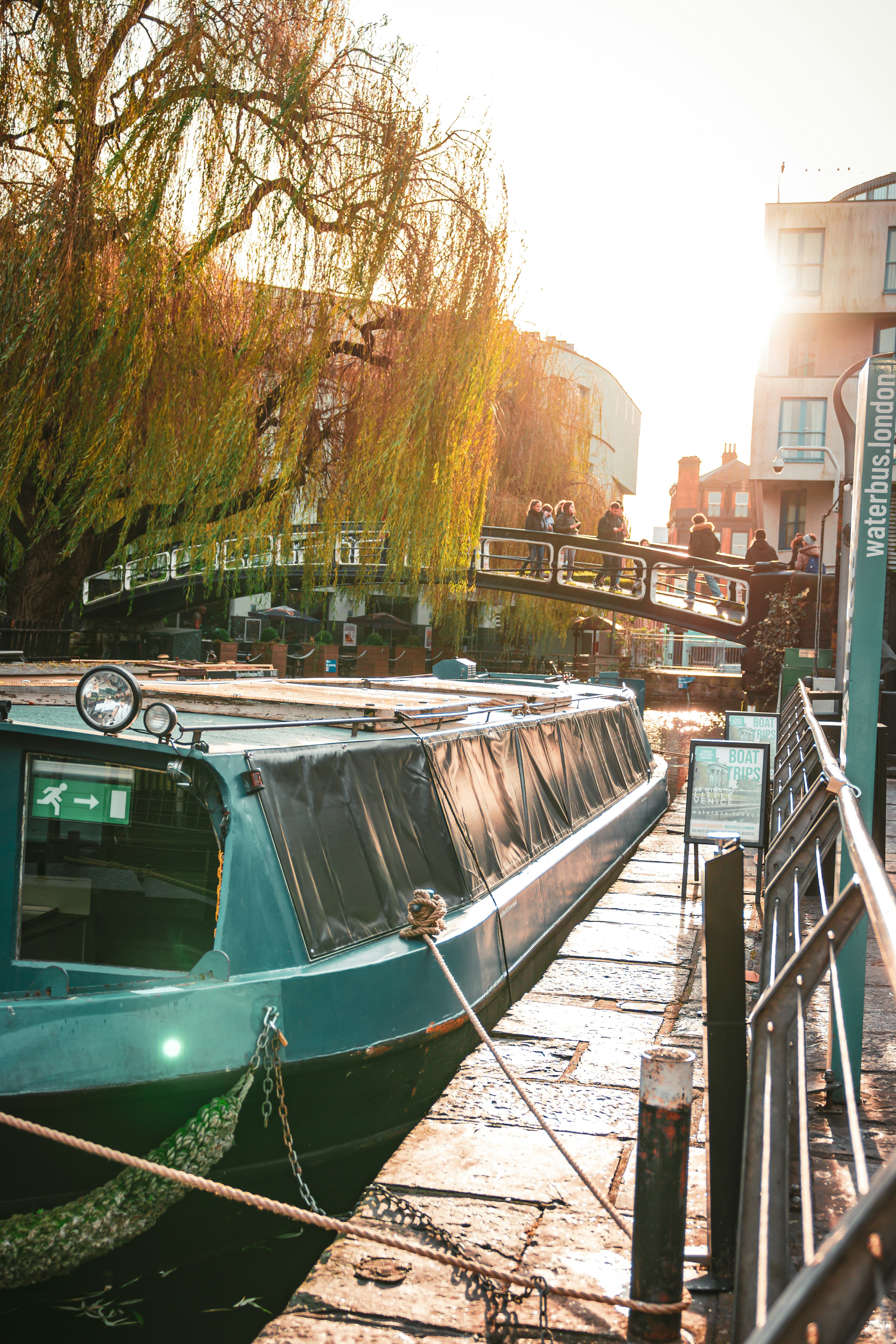 Sunlight on a London canal lined with boats