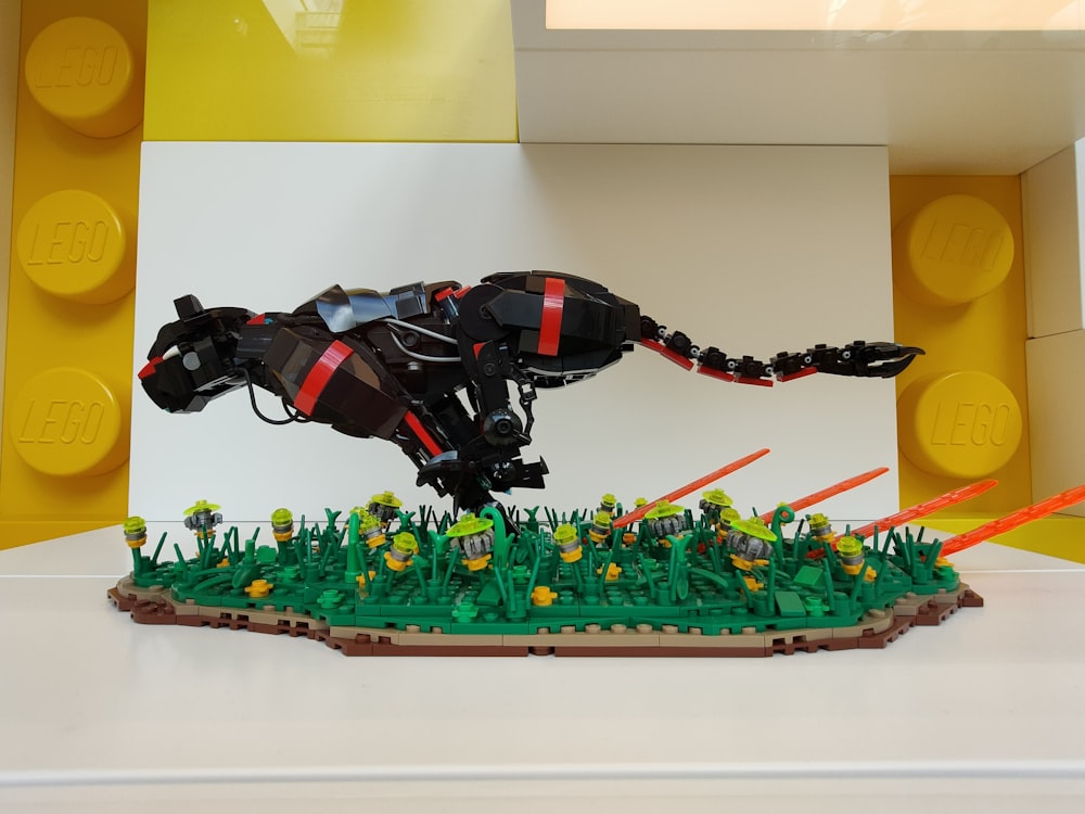 a lego model of a black and red lizard