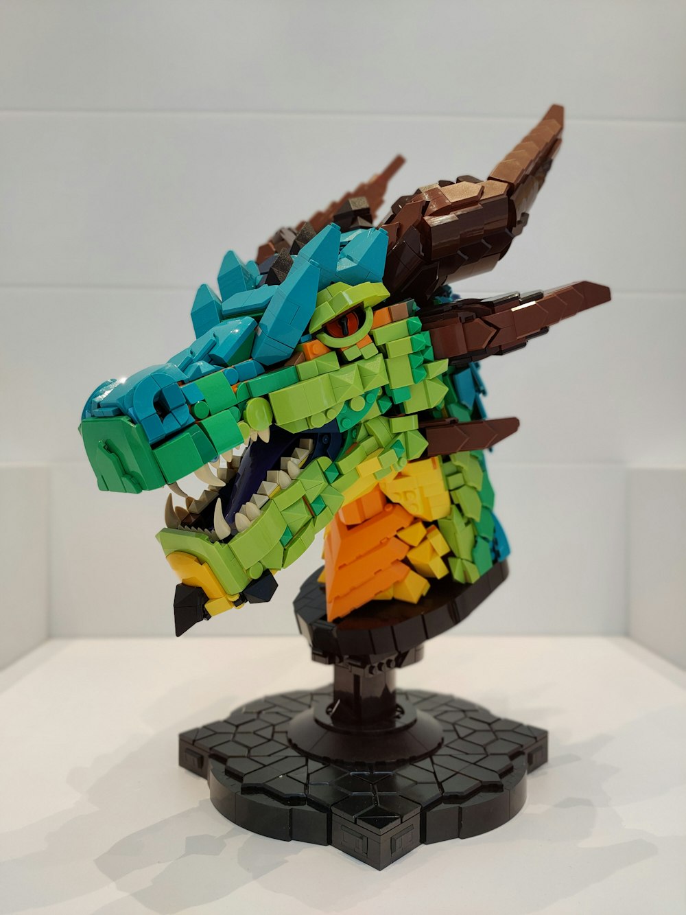 a lego model of a dragon on a stand