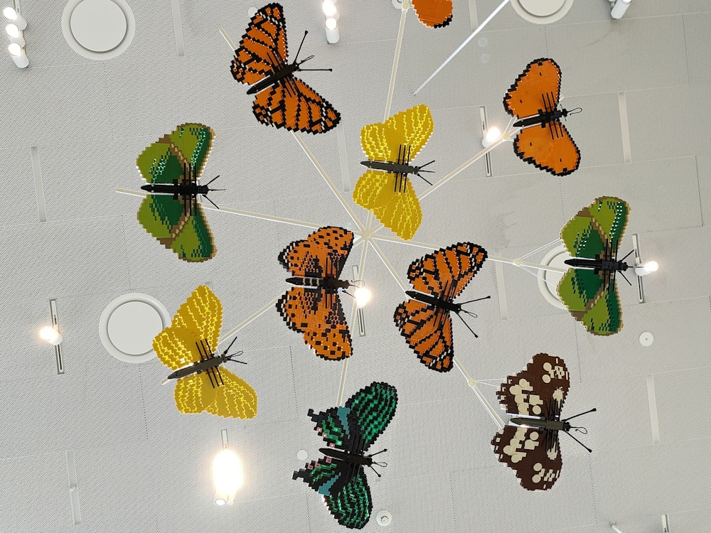 a bunch of butterflies that are hanging from a ceiling
