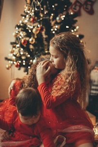 A child receiving a warm hug surrounded by donated gifts.