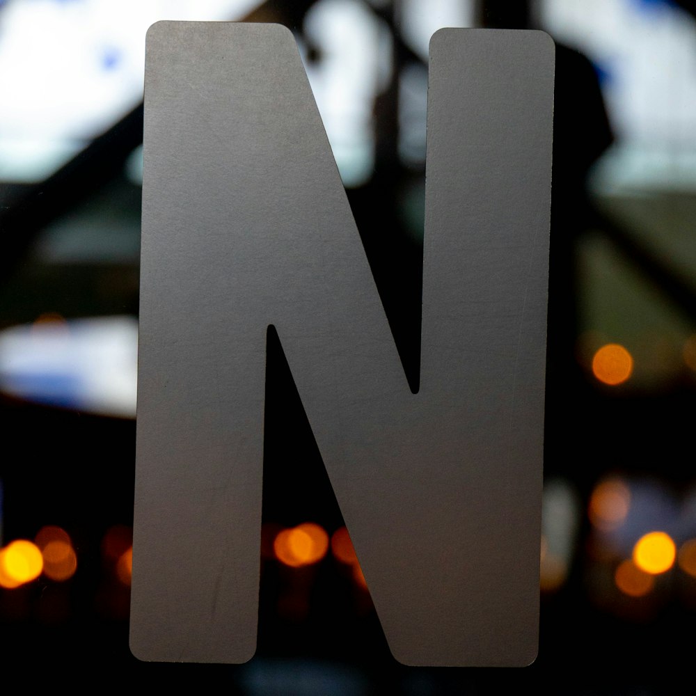a close up of the letter n on a sign