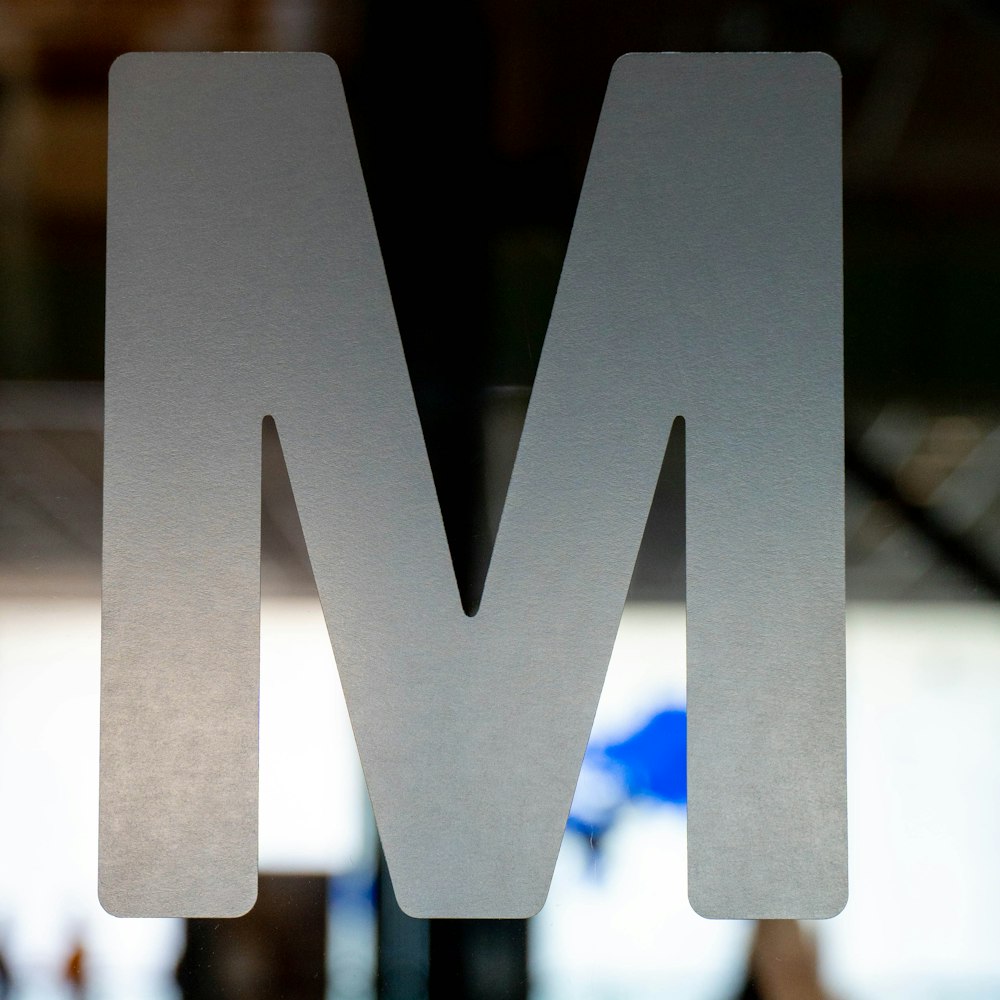 a close up of the letter m on a sign