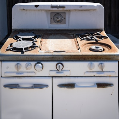 an old white stove with two burners on it