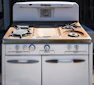 an old white stove with two burners on it