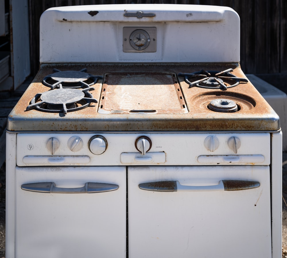 an old white stove with two burners on it