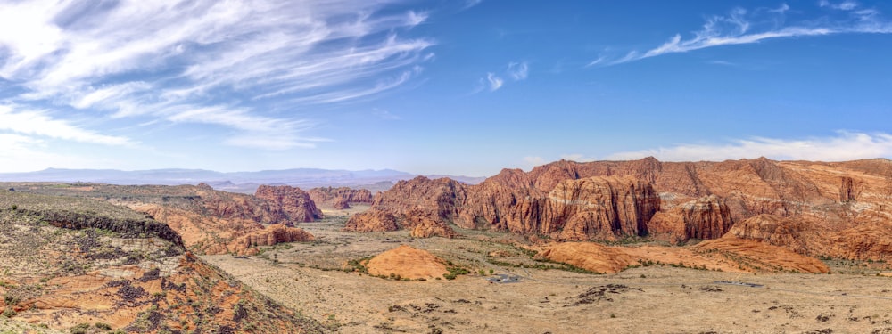 a scenic view of a desert with mountains in the background