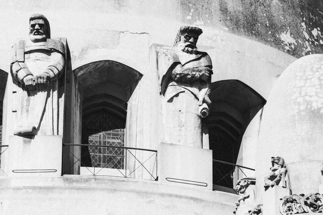 a black and white photo of some statues,