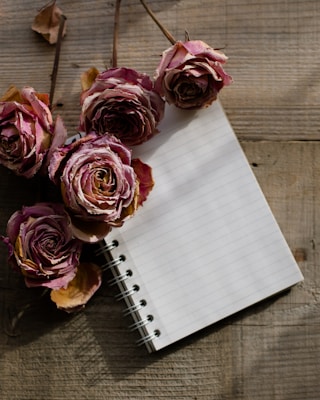 a notebook with a bunch of flowers on top of it