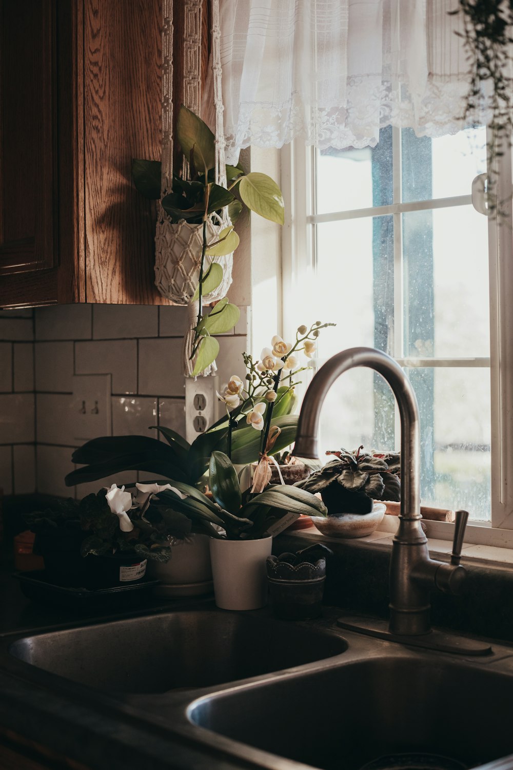 a kitchen sink sitting under a window next to a window