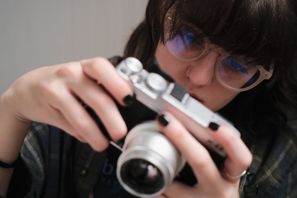 a woman taking a picture with a camera