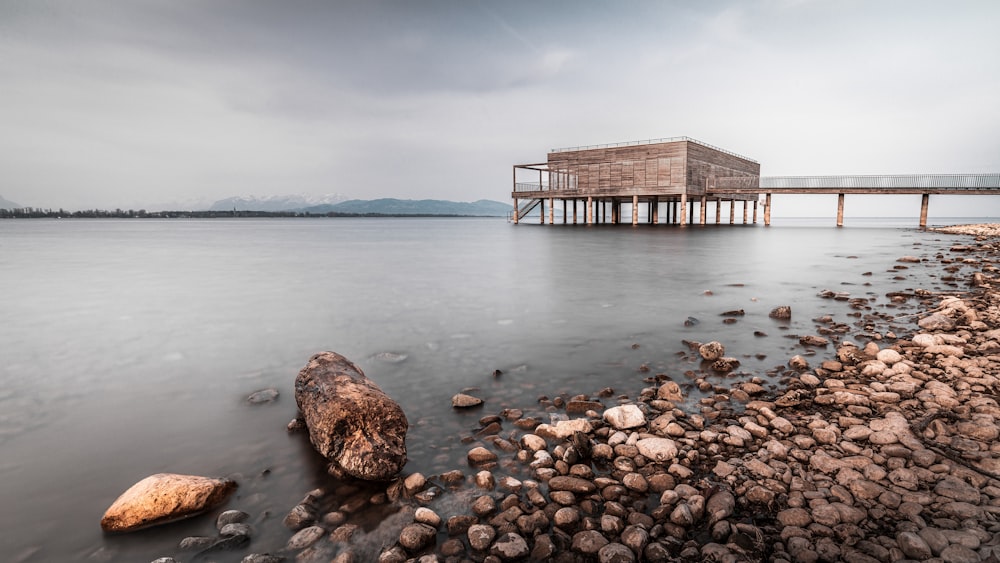 a wooden structure sitting on top of a body of water