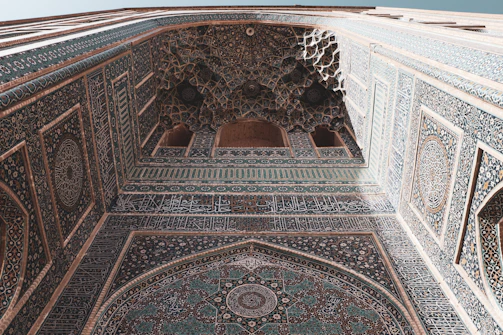 A richly detailed Moorish archway blending into futuristic Afrofuturist patterns, symbolizing cultural fusion.