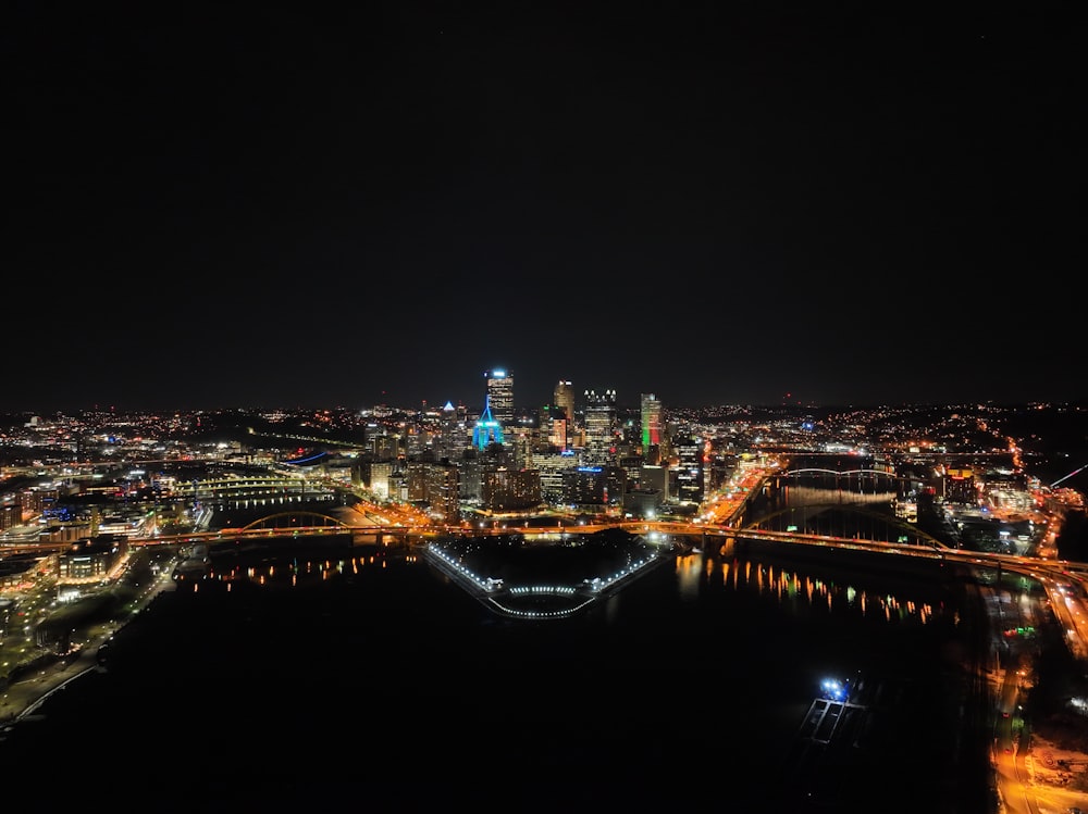 a view of a city at night from the top of a hill